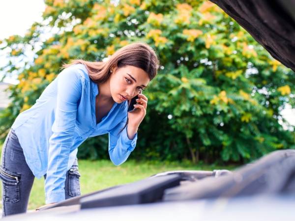 Woman Calling to Fix a Broken Car