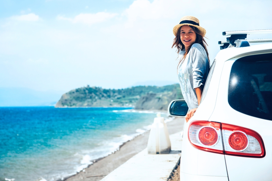 Woman on a Car along Coast