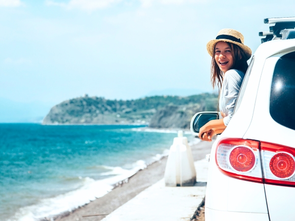 Woman on a Car along Coast