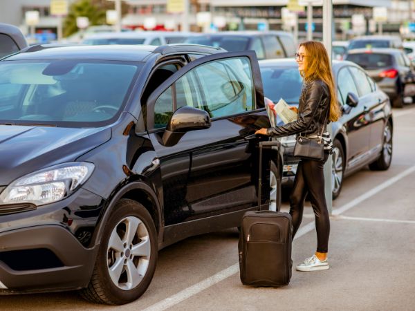 Woman Entering Rental Car at the Airport